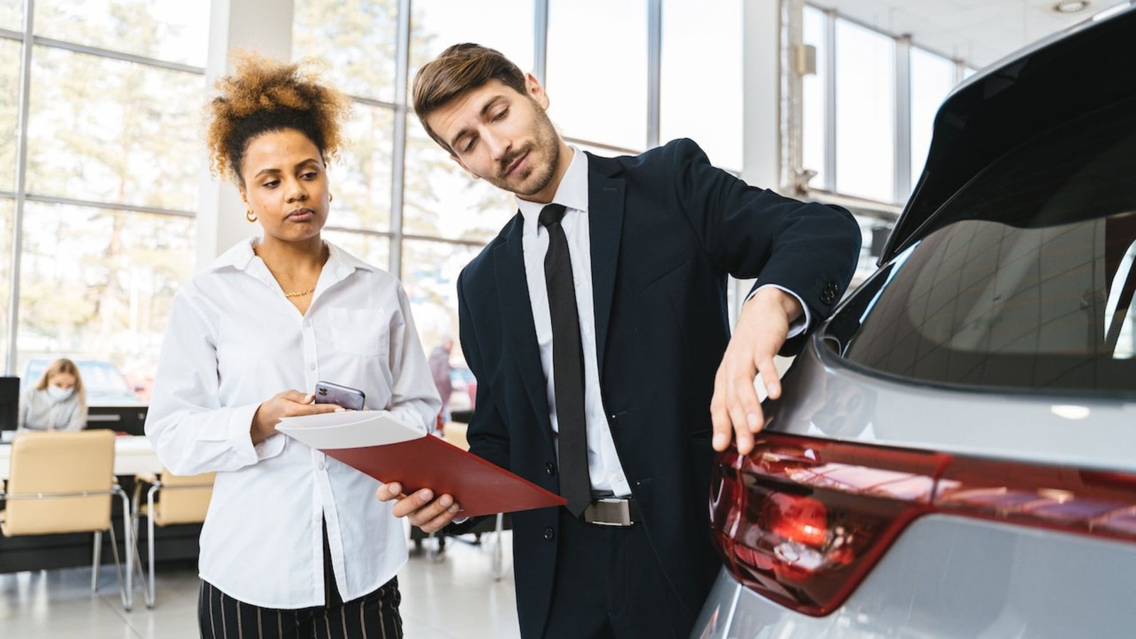 2 People Looking at a Car Showing What to Look for When Buying a Used Car
